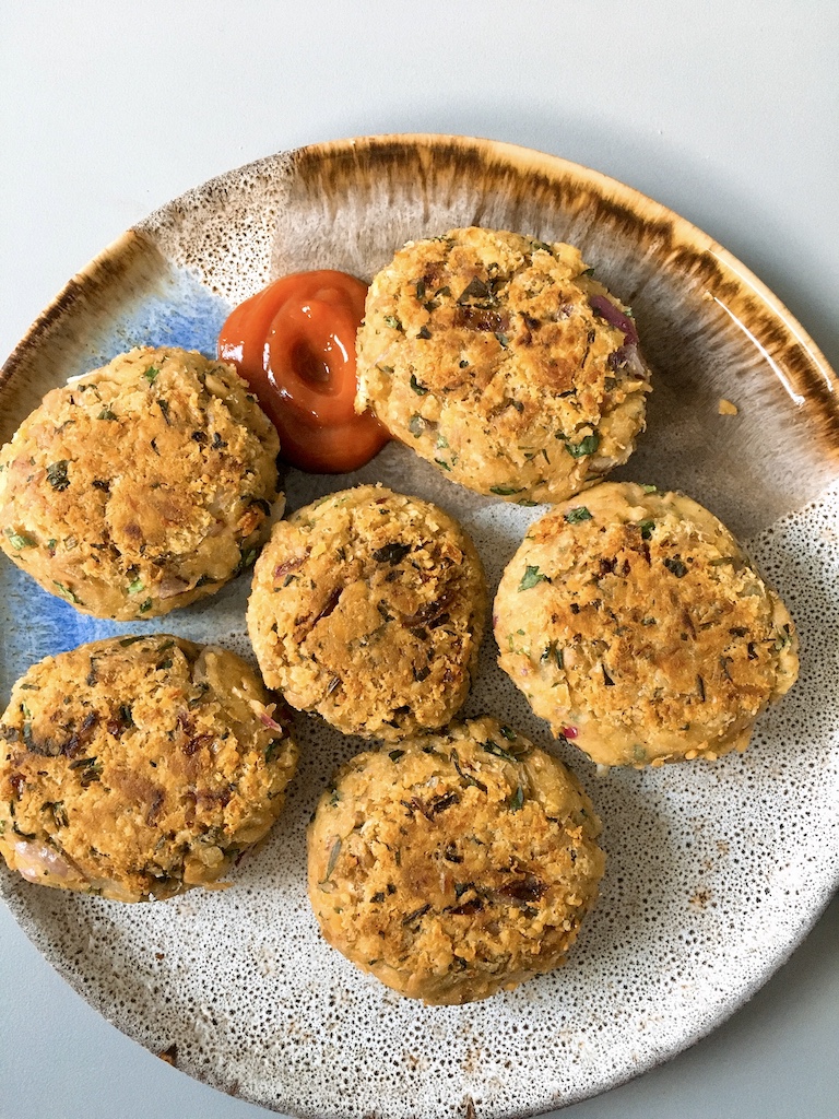 Chickpea and tuna patties with ketchup.