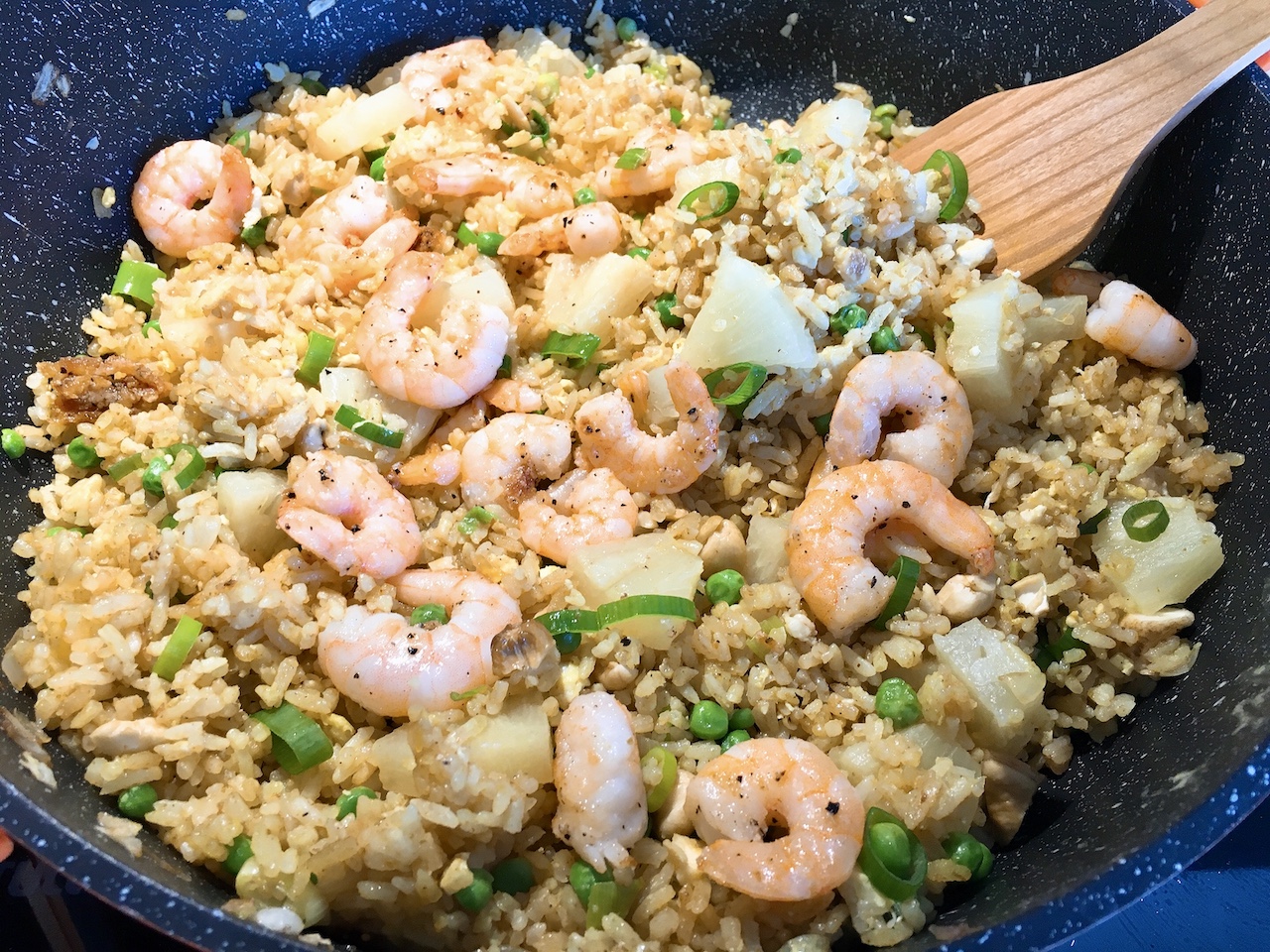 Making Thai pineapple fried rice in a big pot.