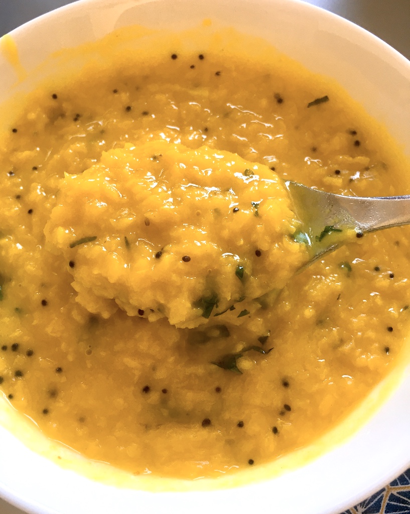 Spoon up the moong dal made with garlic tadka.