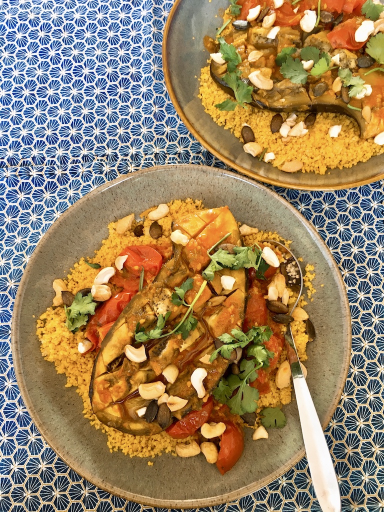 Aubergine curry over a bed of spiced couscous.