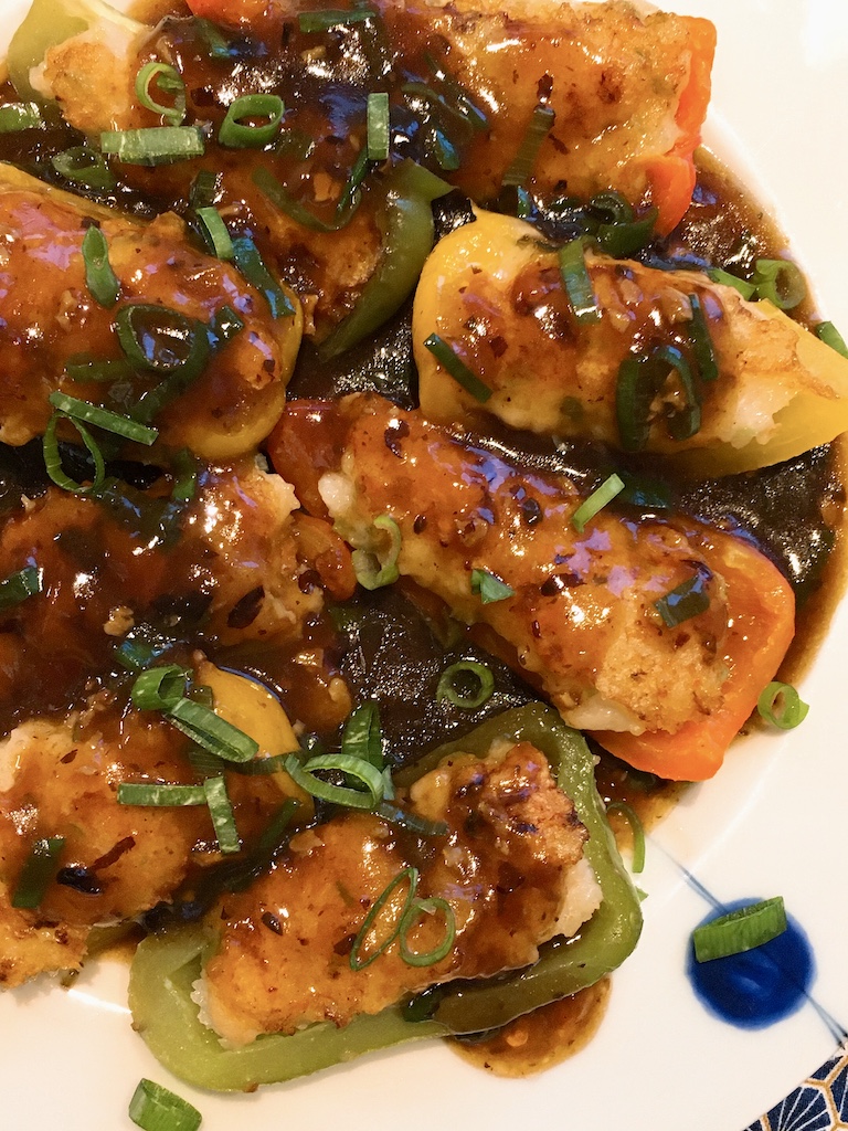 A close-up of shrimp stuffed peppers with black bean sauce.