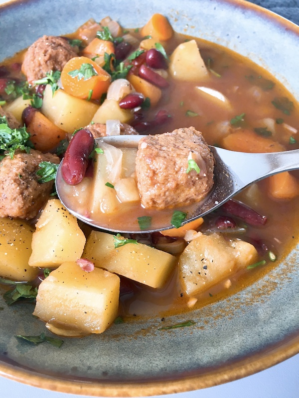 Kidney bean stew and IKEA meatball on a spoon.