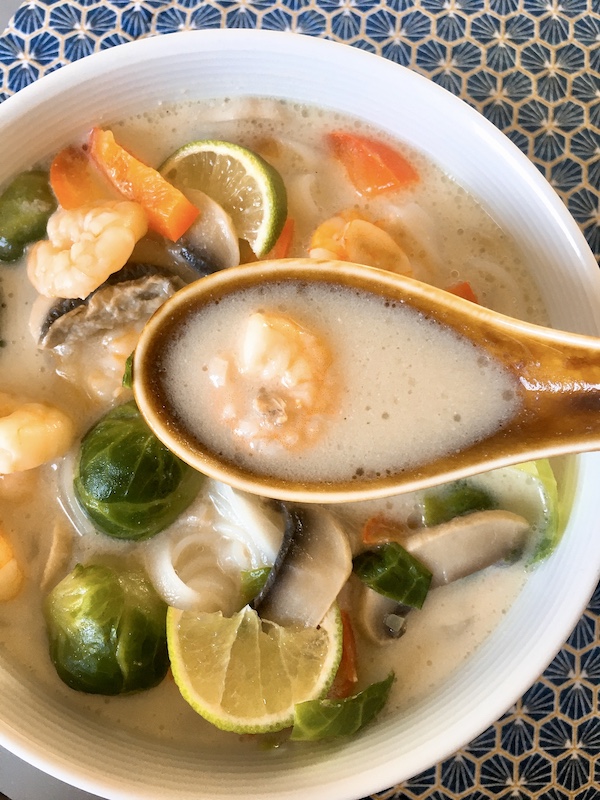 A spoonful of Tom Kha Goong soup.