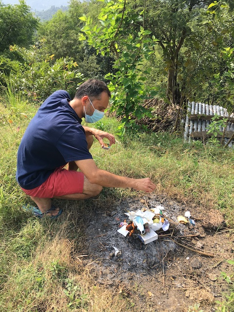 Burning own trash in a village in India.