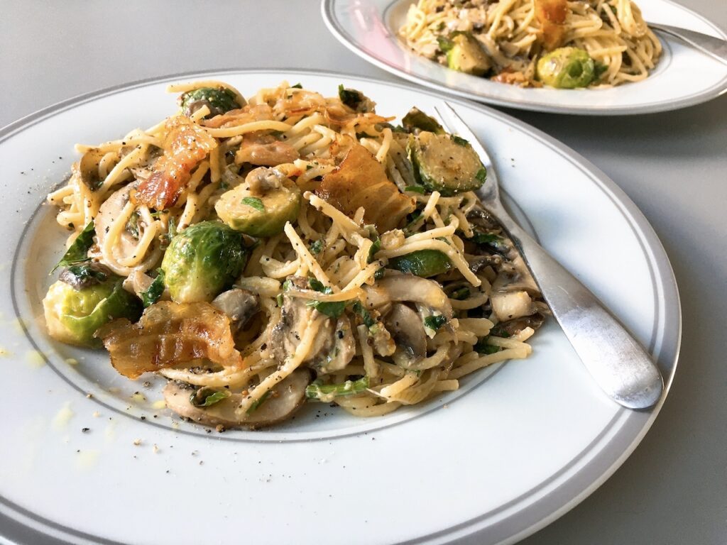 Cream sauce pasta made with bacon, Brussels sprouts and mushrooms.