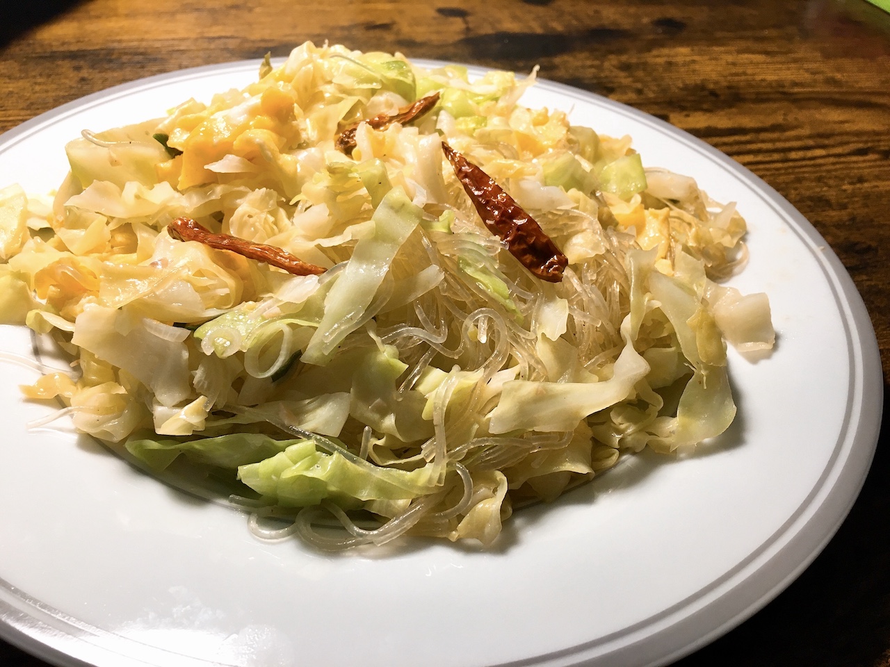 Spicy stir-fried glass noodles with cabbage.