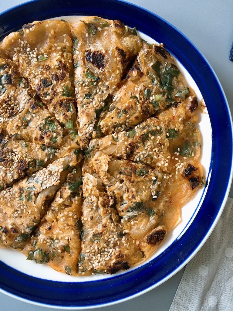 Korean kimchi pancake with Chinese chives and sesame seeds.