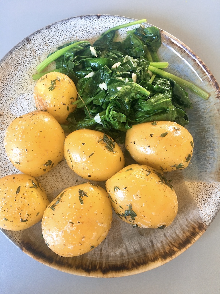 Boiled potatoes and garlicky spinach as a side dish.