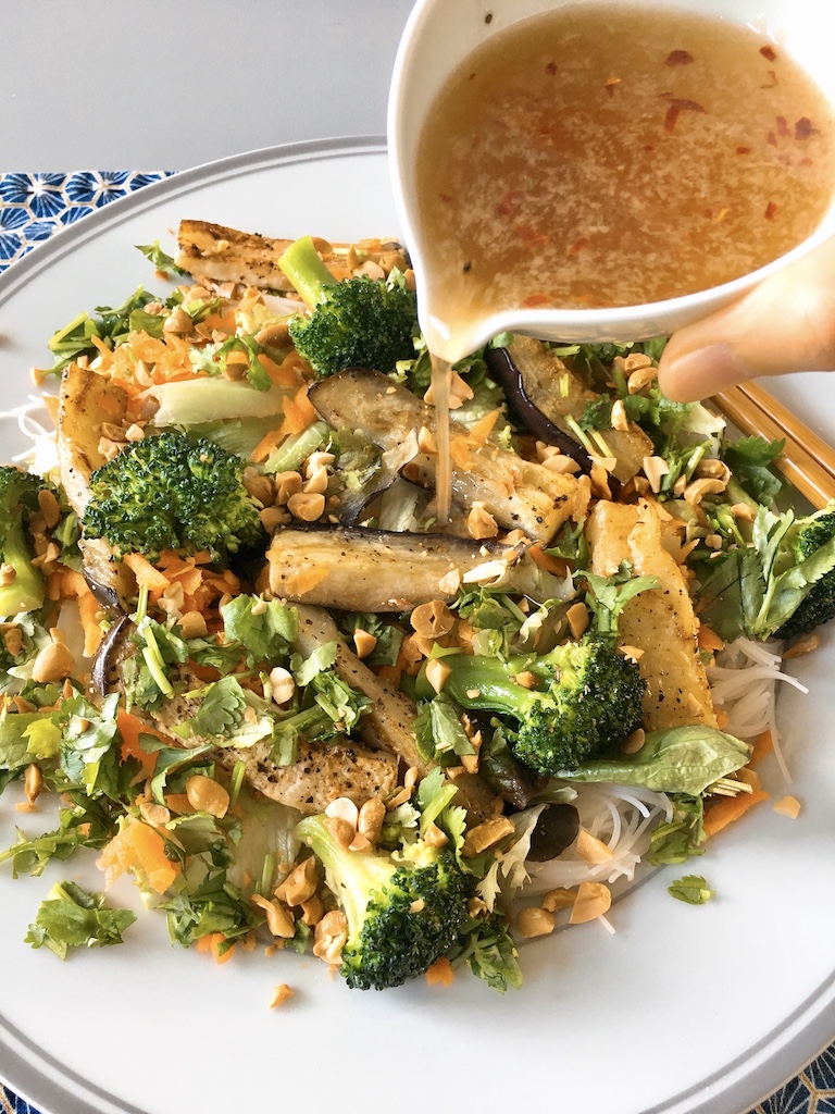 Pouring over the fish sauce vinaigrette over the aubergine vermicelli salad.