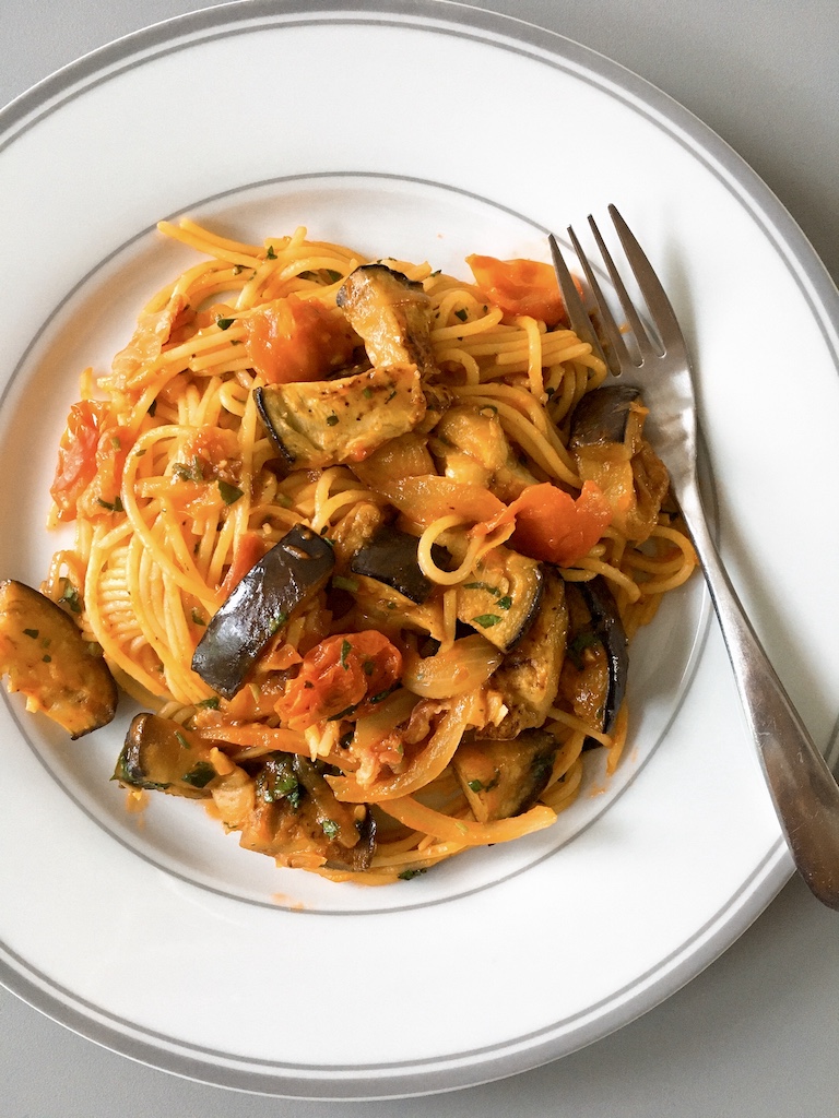 Melting aubergine and bacon spaghetti in tomato sauce.