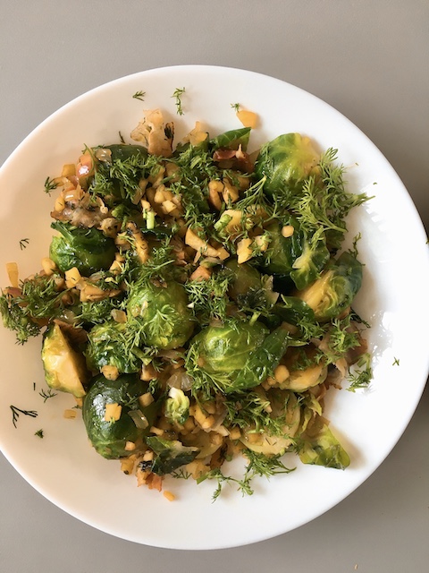 A side dish made with Brussels sprouts, bacon, apple and dill.