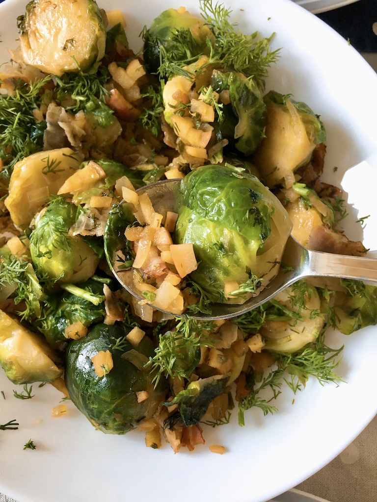 A spoonful of Brussels sprouts, bacon, apple and dill.