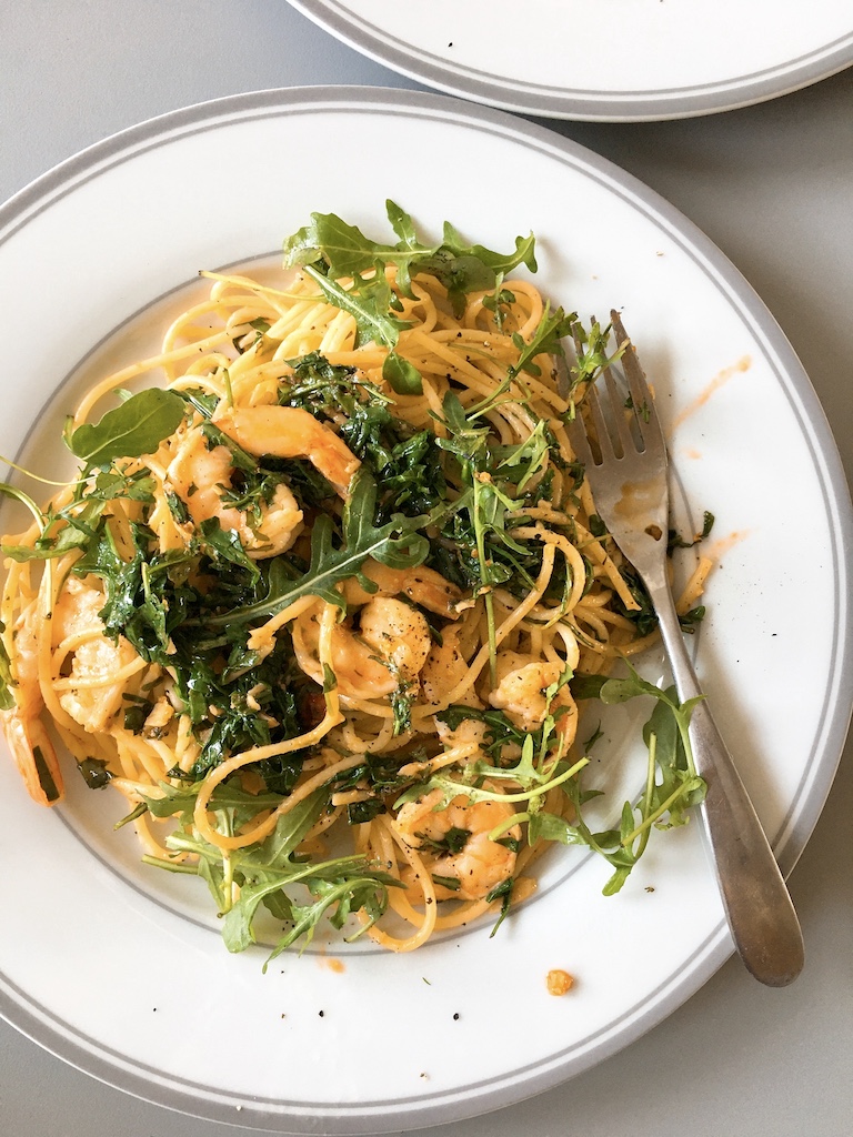 Prawn spaghetti with rocket leaves.