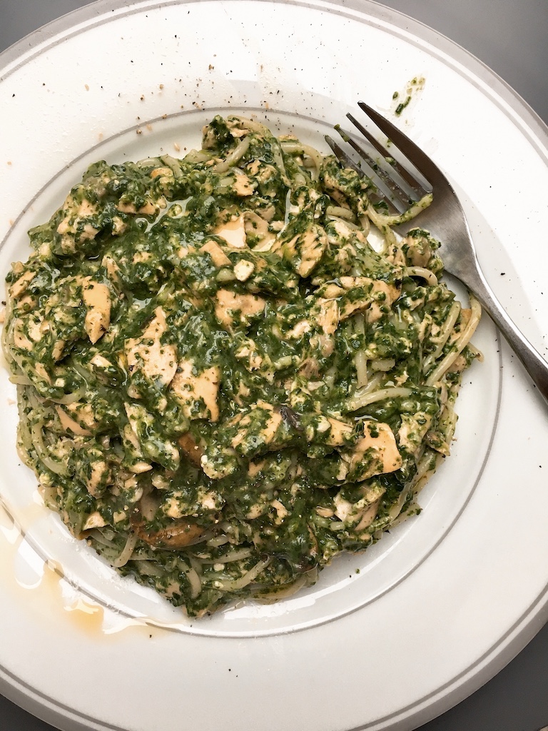 Salmon spinach spaghetti in forest sauce.