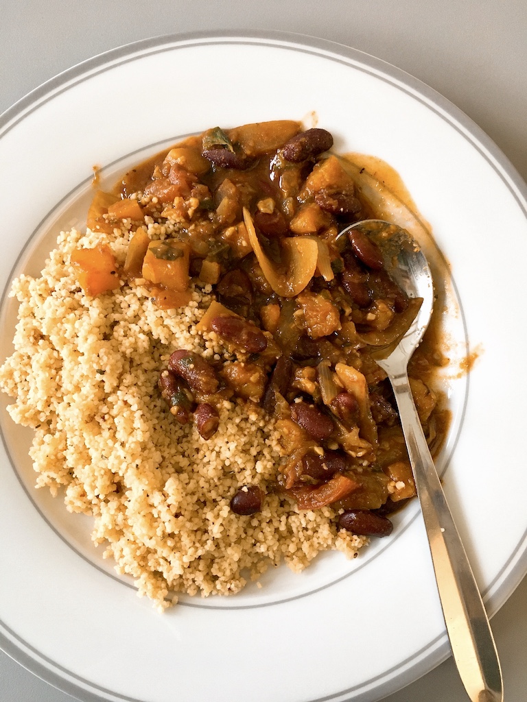 Vegan feijoada with kidney beans and butternut squash, served with couscous.