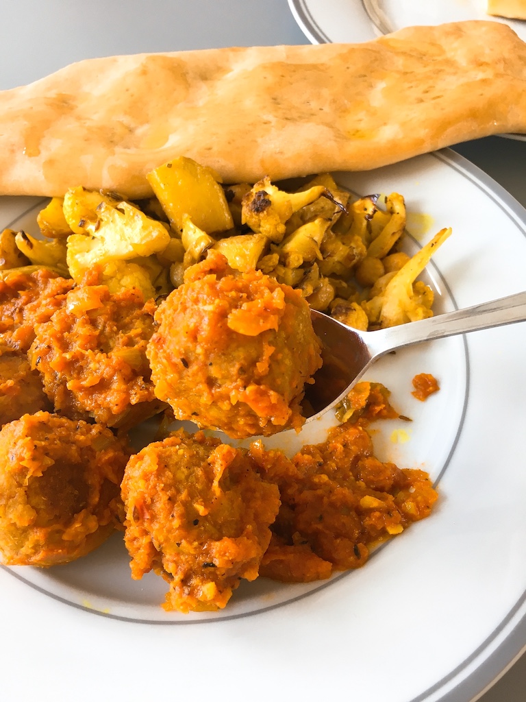 Vegan meatball with spiced tomato sauce.