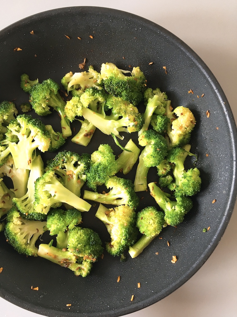 Stir-fry broccoli with garlic and cumin.