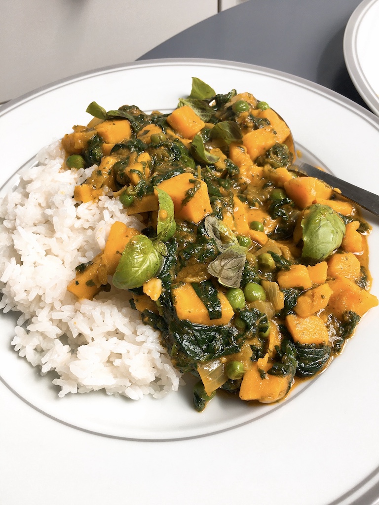 Thai yellow curry with sweet potatoes and spinach.