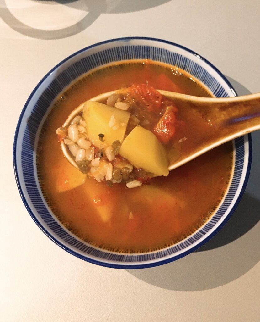 Vegan Canton soup with tomato, potato and lentil.