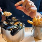 Enjoying a big fat mussels with fries.