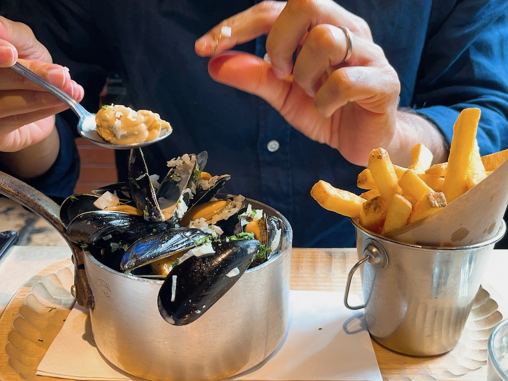 Enjoying a big fat mussels with fries.