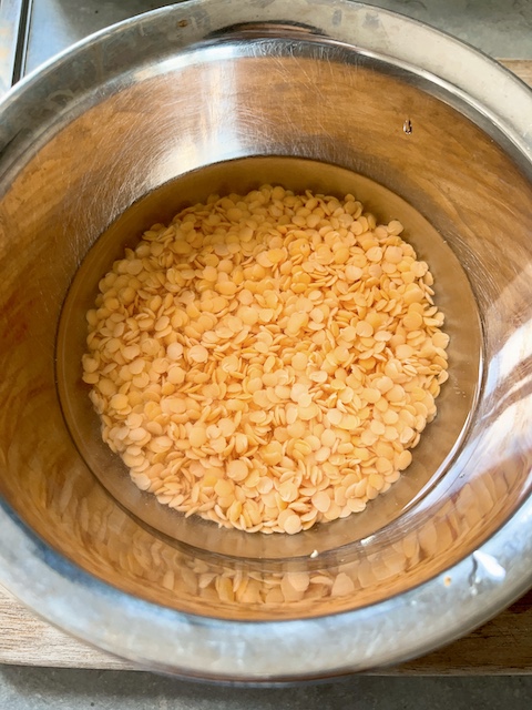 soaking red split lentils for the stew.