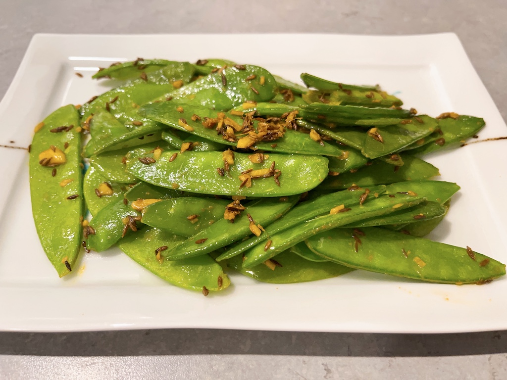 Stir-fry mangetout with garlic, cumin and turmeric