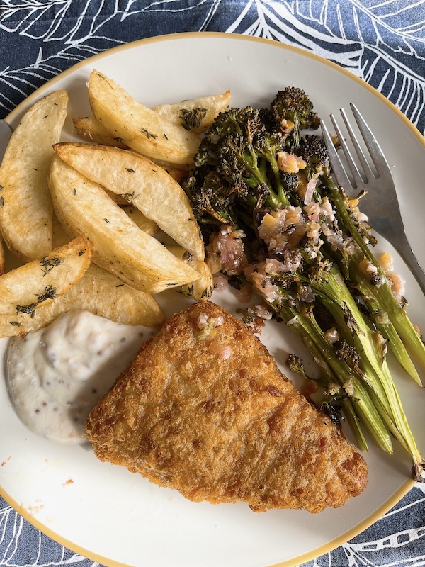 Roasted purple sprouting broccoli with fish and chips.