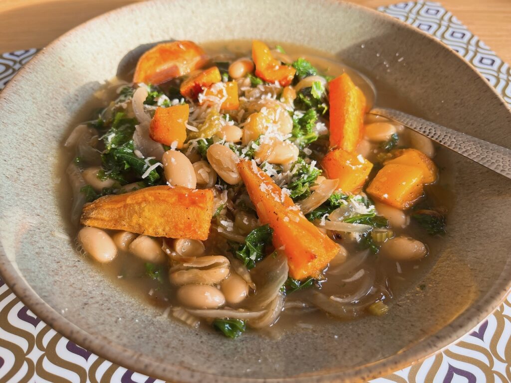 Vegan bean stew with roast squash and kale.