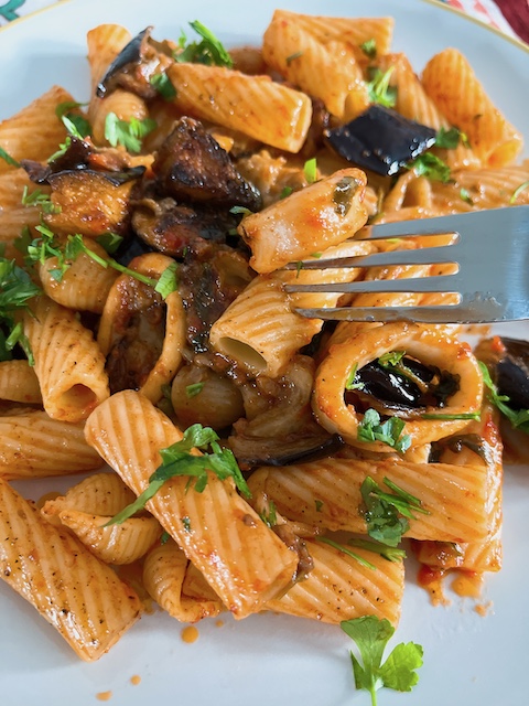 Confit squid with roasted aubergine and tortiglioni.