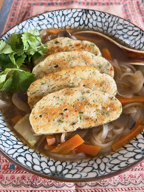 Vietnamese fishcakes with dill on a soup noodles.