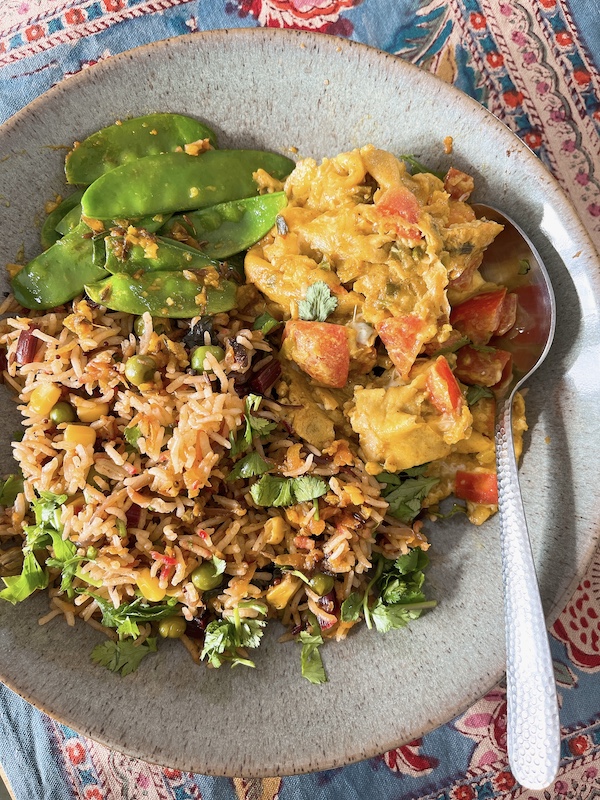 Masala egg with vegetable pulao and cumin stir-fried mangetout.