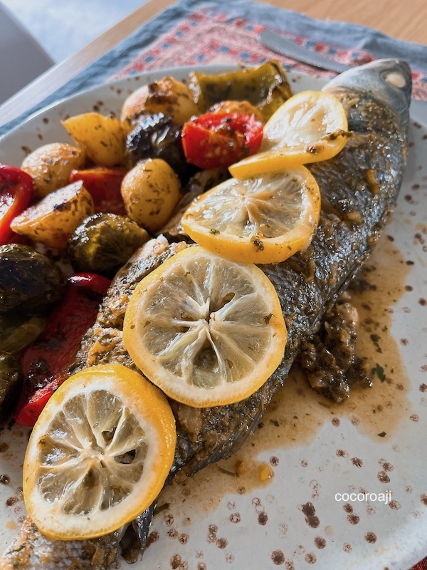 Moroccan oven roasted fish tagine with chermoula and vegetables.