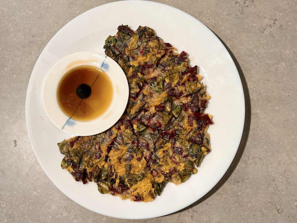 A savoury pancake made with beet greens.