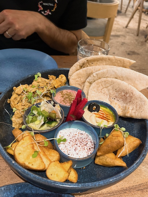 Mediterranean mezze platter in a shopping mall's cafe.