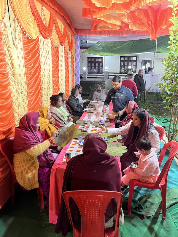 Guests sitting on chairs in an Indian wedding.