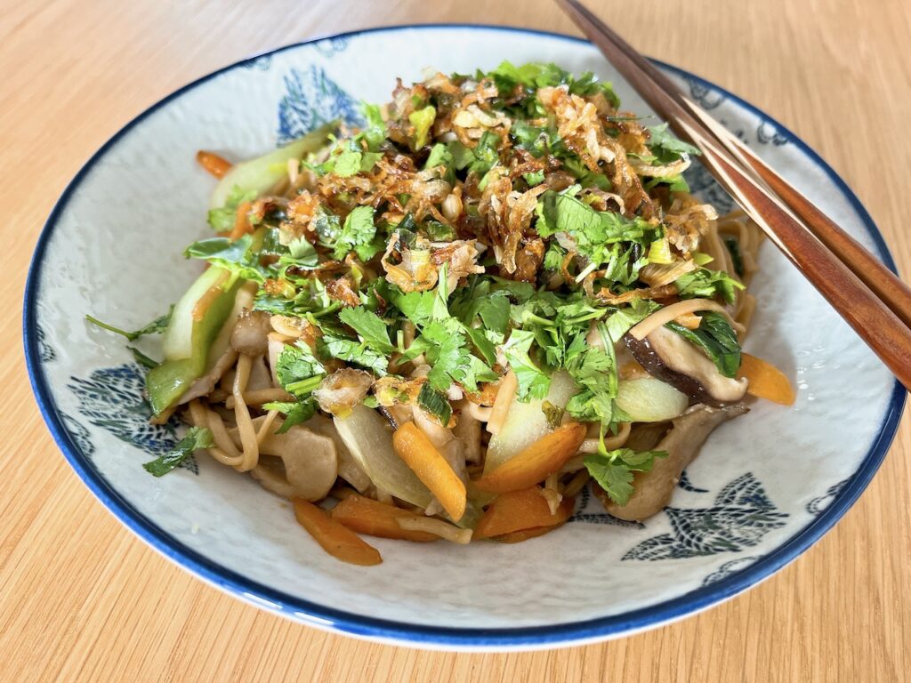 Mushrooms chow mein with crispy shallots.