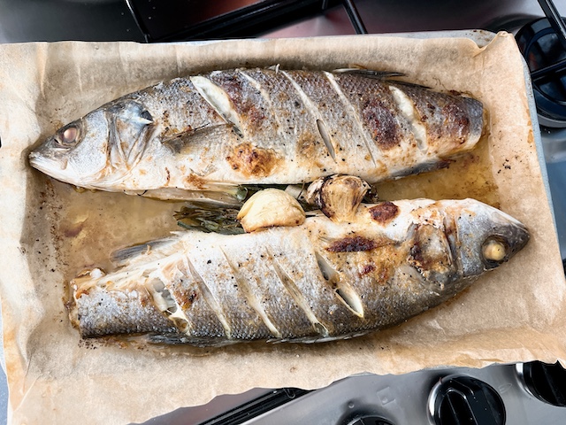 Two whole sea bass after baking.