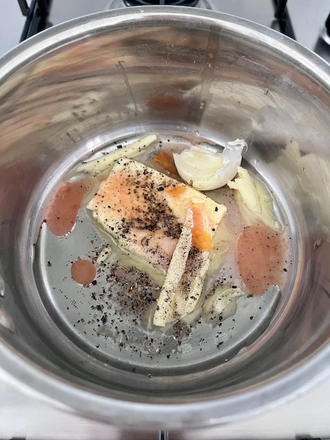 Melting butter with blood orange juice, garlic, salt and pepper.