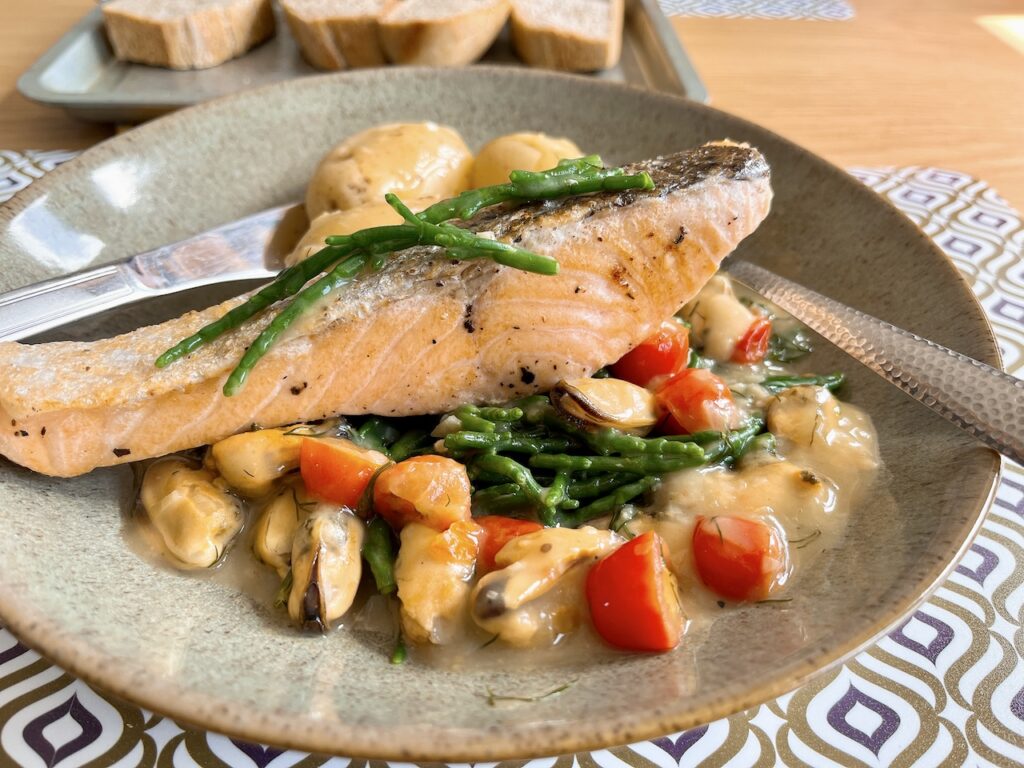 Pan-seared salmon with samphire and mussels velouté.