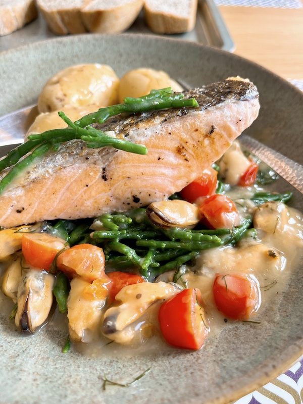 Pan-seared salmon with samphire and mussels velouté.