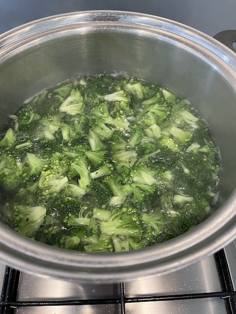 Blanching broccoli in salted water.