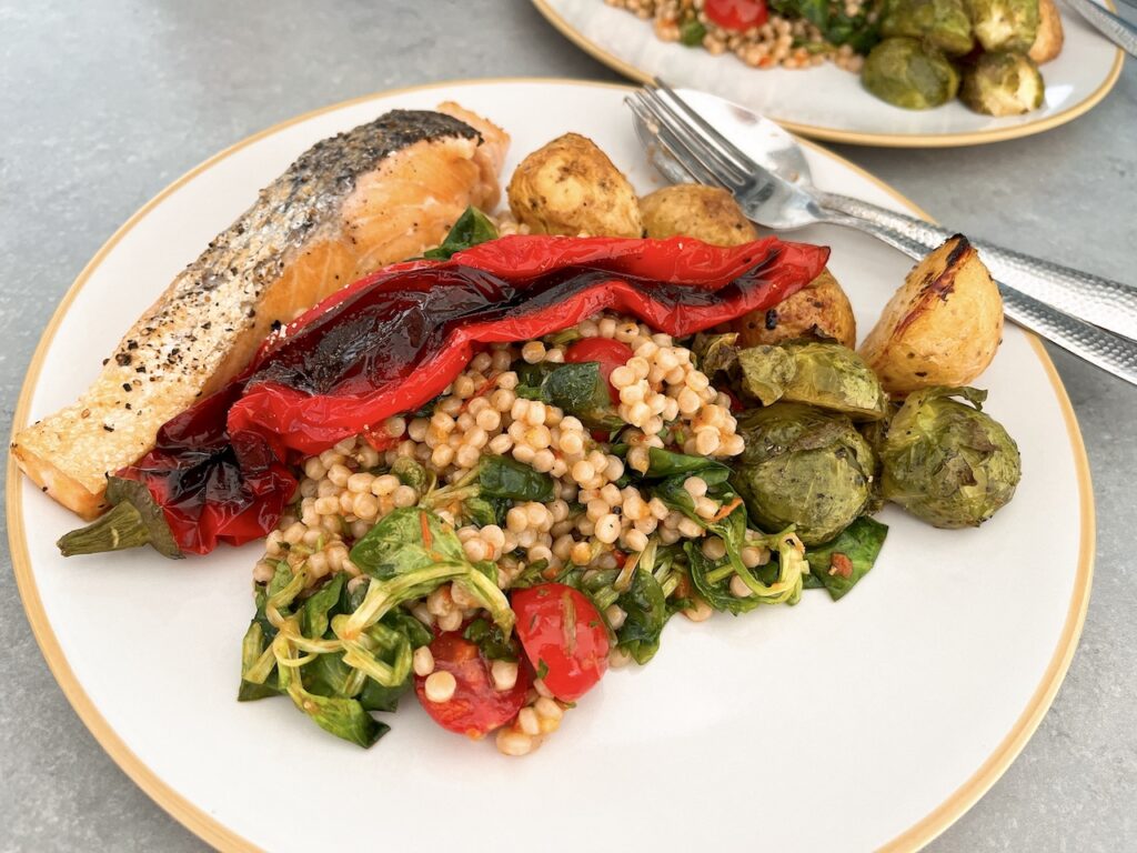 Pan-seared salmon with roasted Romano pepper and giant couscous.