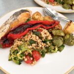 Pan-seared salmon with roasted Romano pepper and giant couscous.