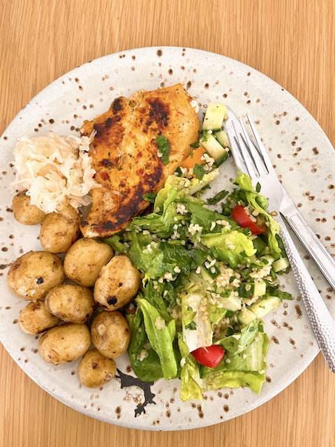 Pan-seared chicken with salad and baby potatoes.