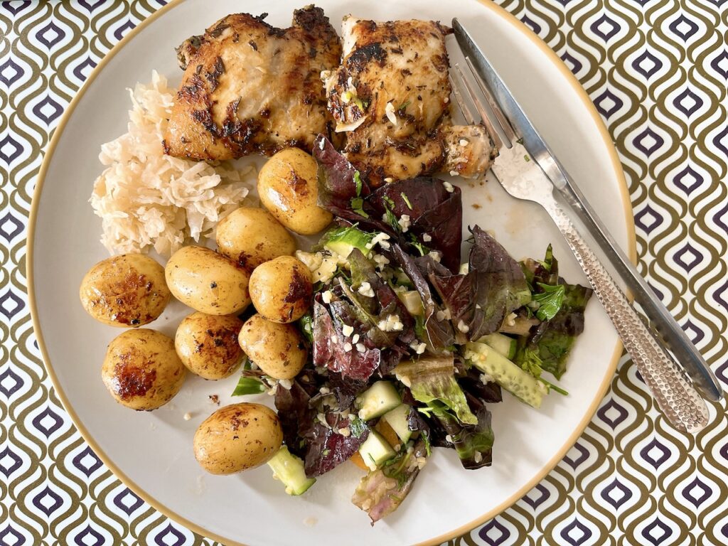 Pan-seared chicken with salad and baby potatoes.