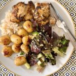 Pan-seared chicken with salad and baby potatoes.