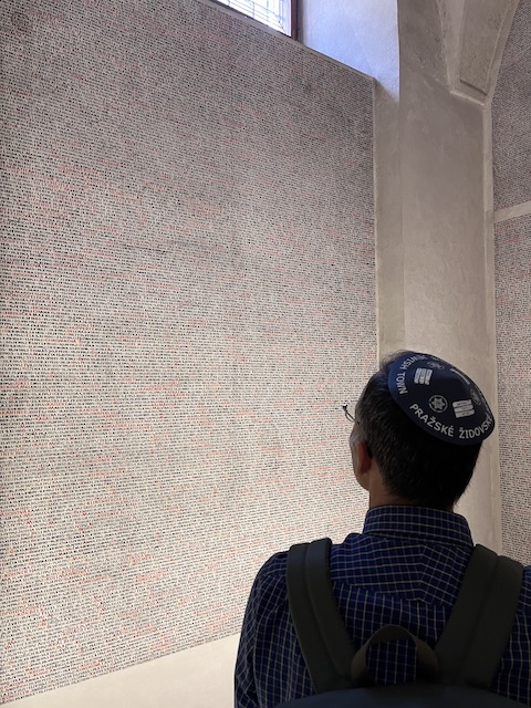 Looking at names on a wall in Pinkas Synagogue.