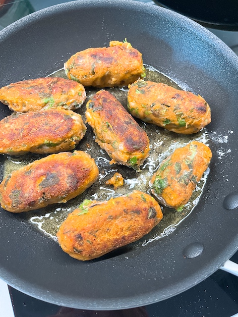 Shallow-frying Turkish carrot fritters.